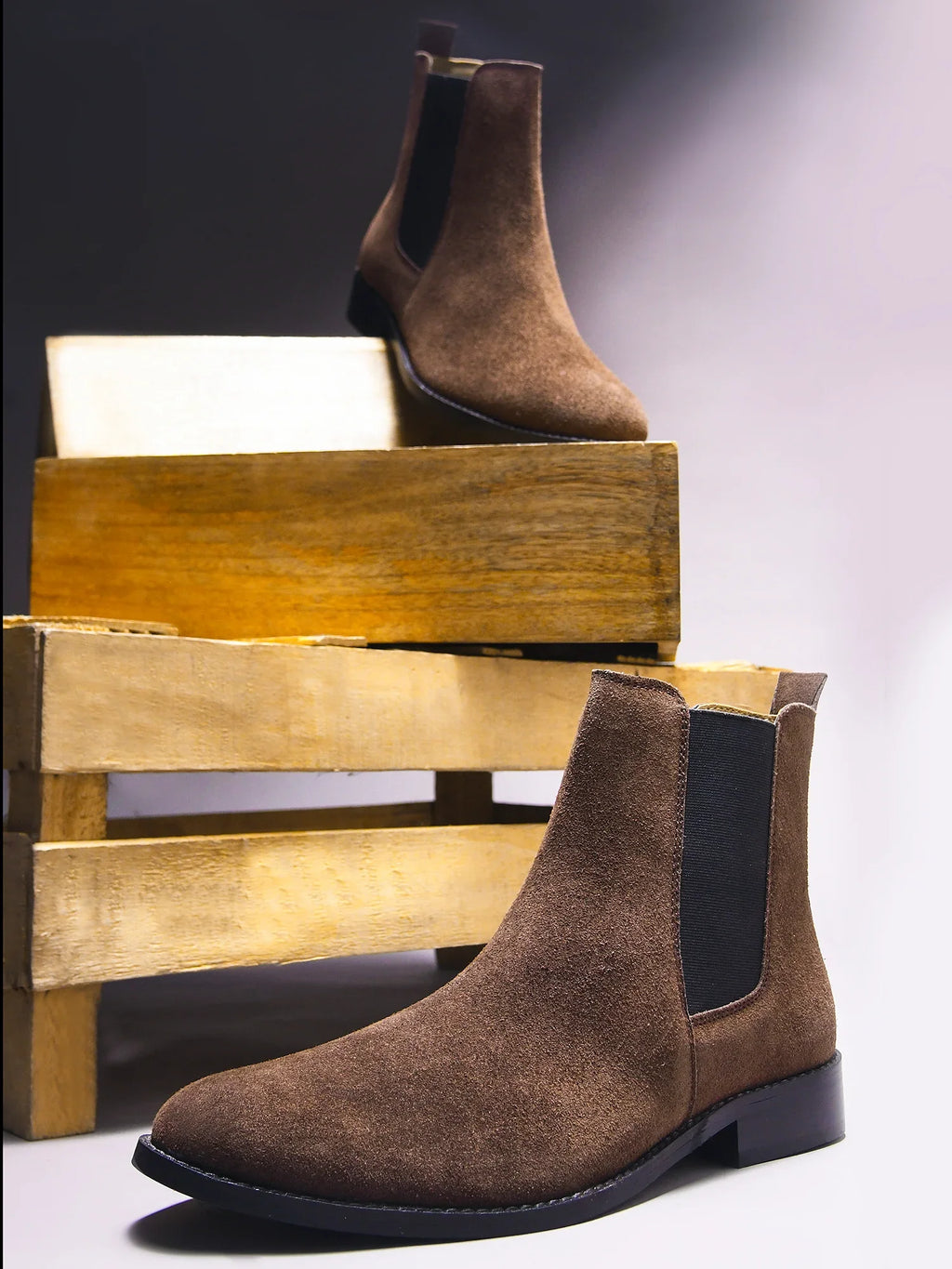 Preview of A men's luxury suede leather Chelsea boot with a mid heel and elastic side panels, in a brown color.