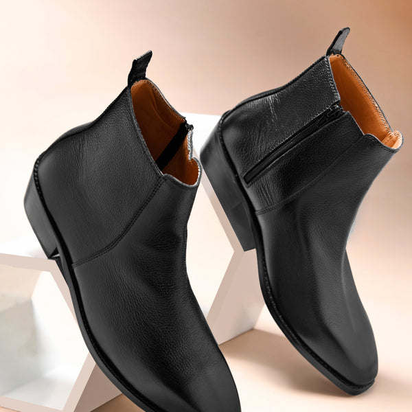 A men's leather side zip boot with a cuban heel, primarily black in color.