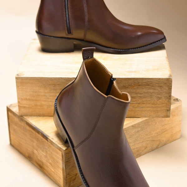 A brown, side zip leather boot with a cuban heel for men.