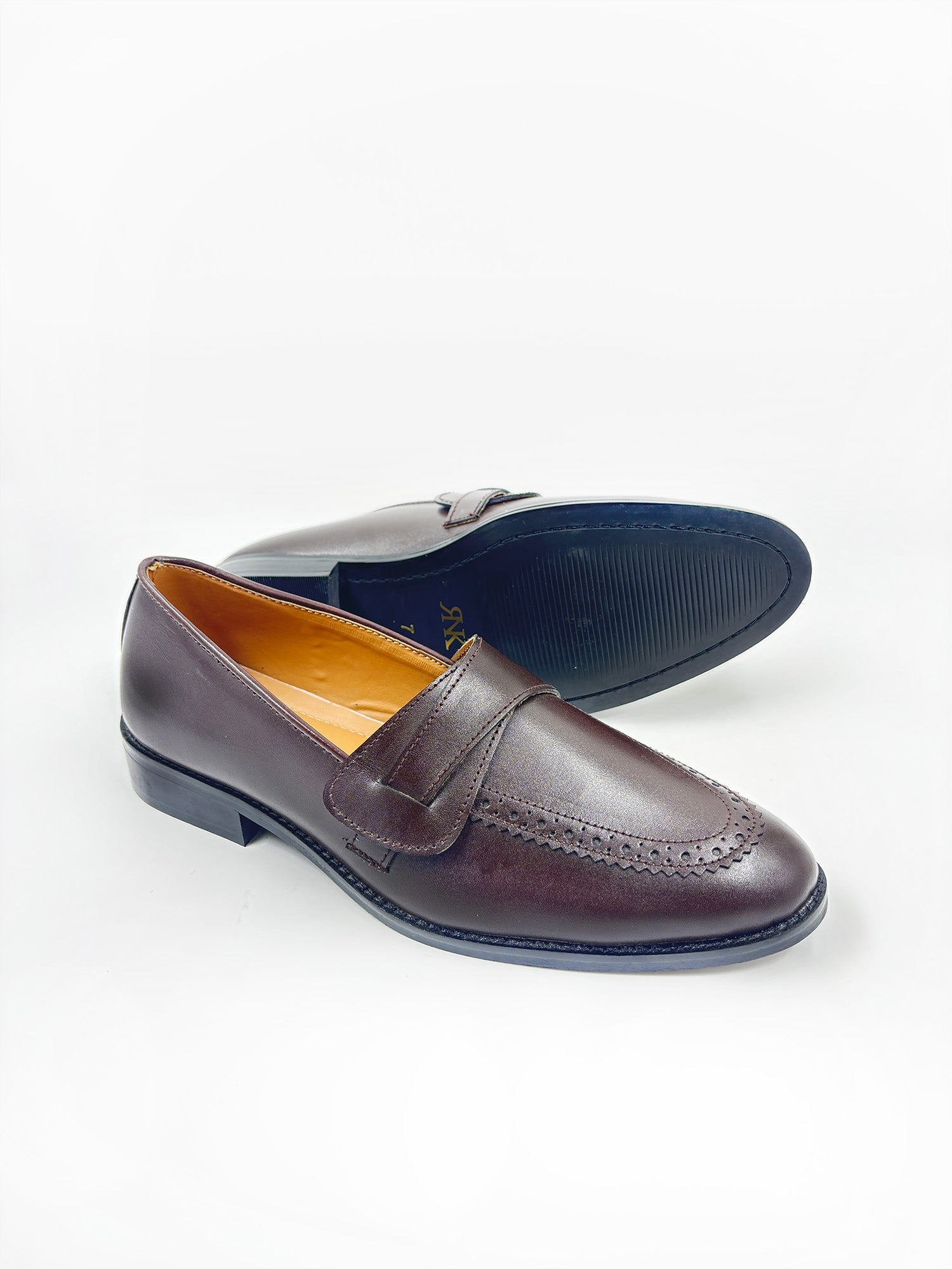 Pair of brown penny loafers on mid heel