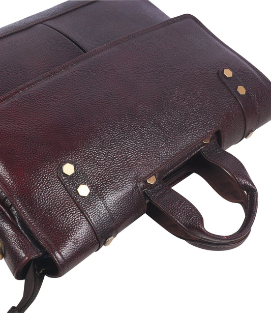 Close-up of a Brown leather messenger bag with gold accents 