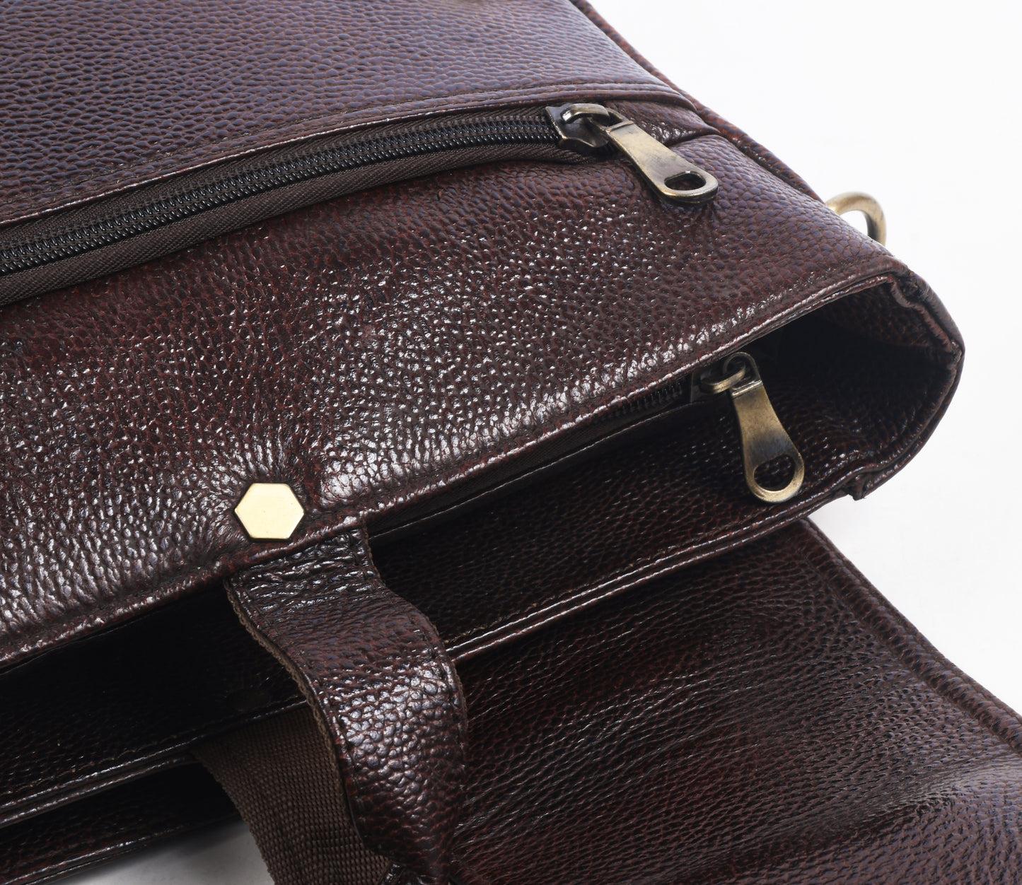 Close up of a Brown leather messenger bag with gold accents 