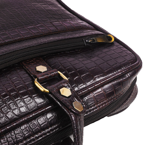 Close-up of a dark brown leather bag with gold accents