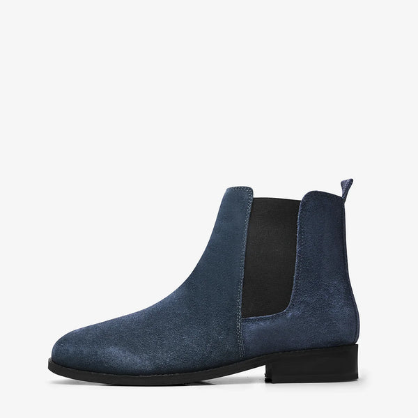 A men's luxury suede leather Chelsea boot with a cuban heel and elastic side panels, in a blue color.
