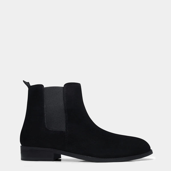 A men's luxury suede leather Chelsea boot with a mid heel and elastic side panels, in a black color.