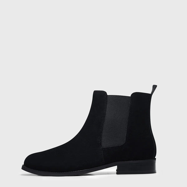 A men's luxury suede leather Chelsea boot with a mid heel and elastic side panels, in a black color.