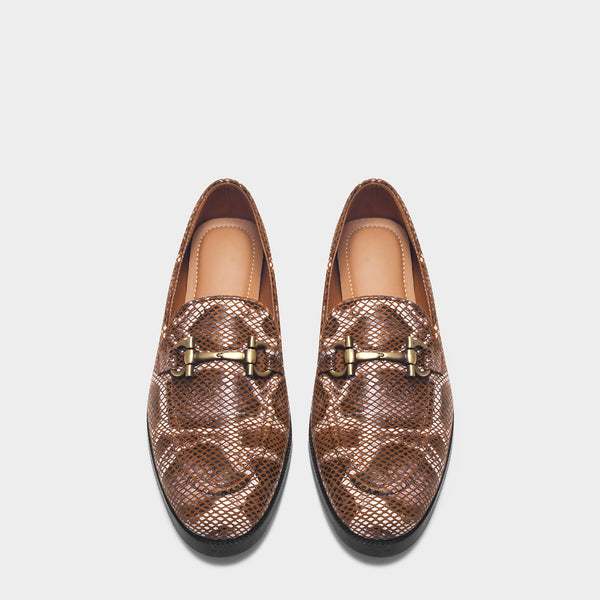 Pair of brown patterned loafers with gold buckles on a white background