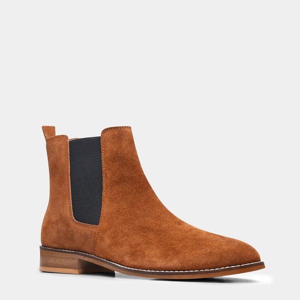 A men's luxury suede leather Chelsea boot with a mid heel and elastic side panels, in a tan color.