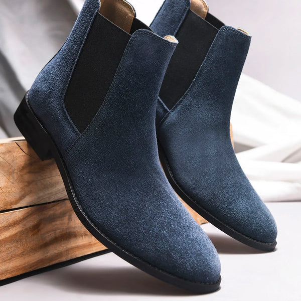 A men's luxury suede leather Chelsea boot with a cuban heel and elastic side panels, in a blue color.