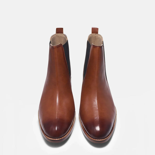 Brown leather Chelsea boot with side elastic and mid heel on a white background