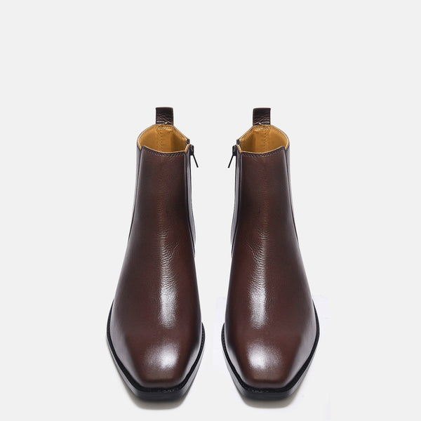 A brown, side zip leather boot with a cuban heel for men.