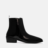 A man's patent leather boot in black or a Cuban heel