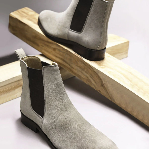 A men's luxury suede leather Chelsea boot with a cuban heel and elastic side panels, in a gray color.