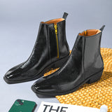 Pair of a Black patent leather boots with side zipper on a Cuban heel