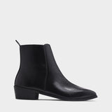 Black patent leather boots with side zipper on a Cuban heel