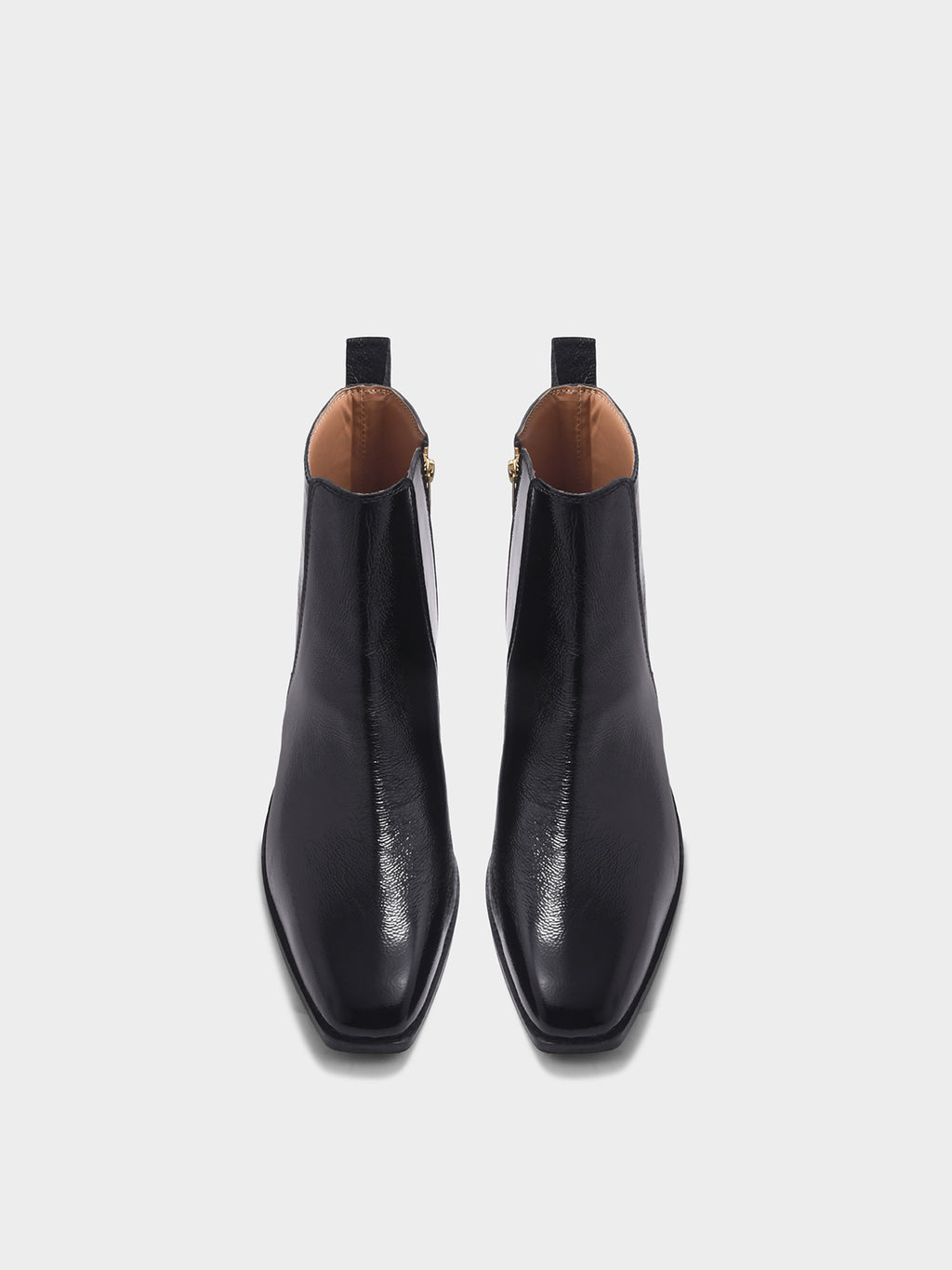 Preview of Pair of a black patent leather boots with side zipper on a mid heel