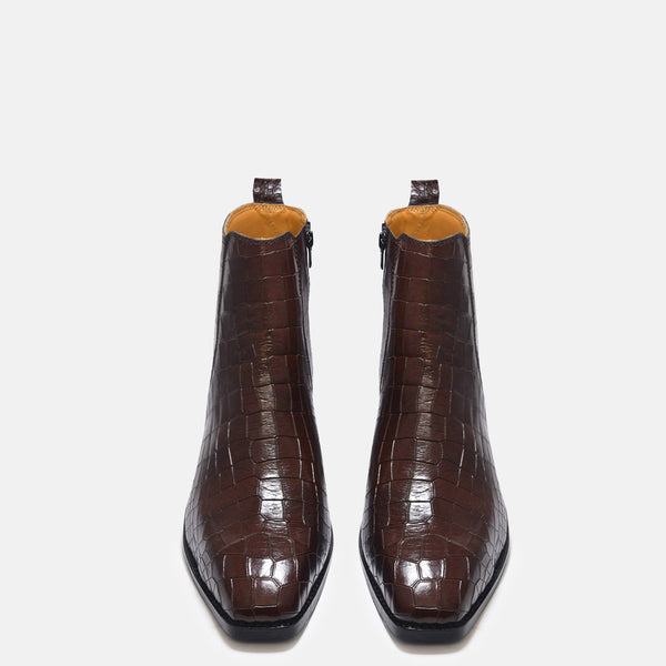 A brown leather side zip boot with a crocodile pattern and a Cuban heel.