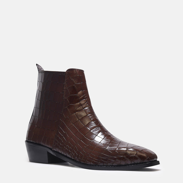 A brown leather side zip boot with a crocodile pattern and a Cuban heel.