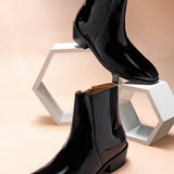 A man's patent leather boot in black or a Cuban heel