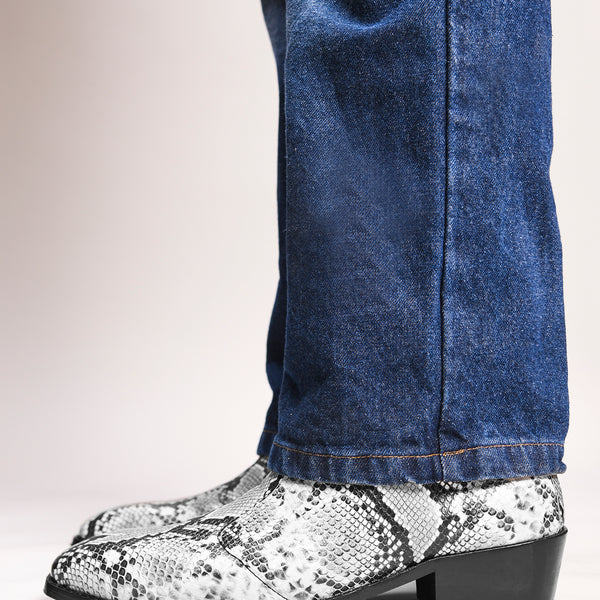 A pair of black and white snake printed leather boot with square toe and a black colour Cuban heel