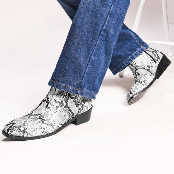 A pair of black and white snake printed leather boot with square toe and a black colour Cuban heel