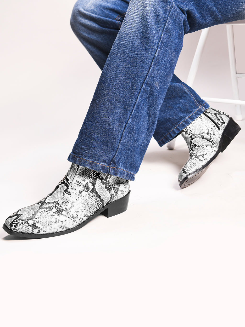 Preview of A pair of black and white snake printed leather boot with square toe and a black colour Cuban heel
