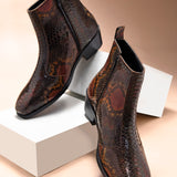 A men's leather boot with a snake-textured boot, featuring a Cuban heel and a side zipper.