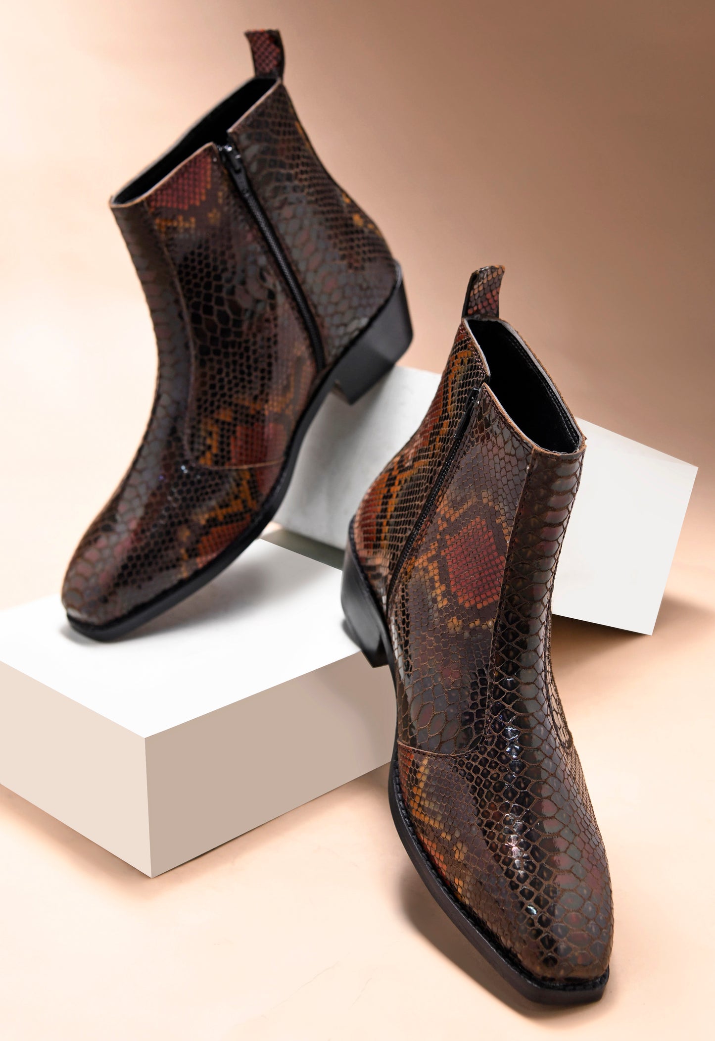 A men's leather boot with a snake-textured boot, featuring a Cuban heel and a side zipper.