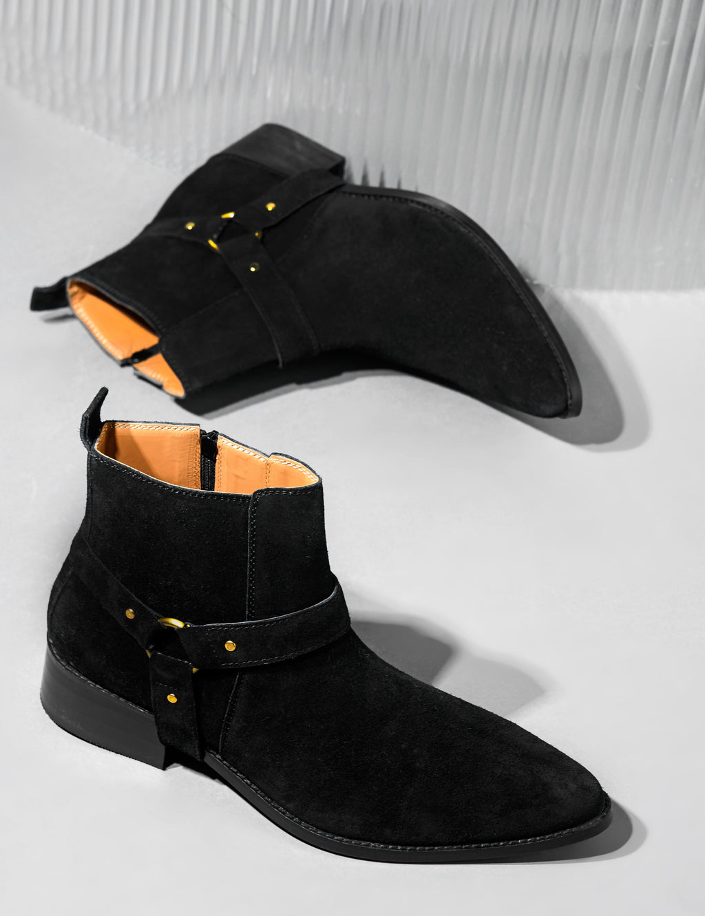 Preview of Phantom black suede harness boots for men featuring a pointed toe, side zip closure, and attached leather thong strap – luxury ankle boots by RNK Luxe for bold, stylish looks.