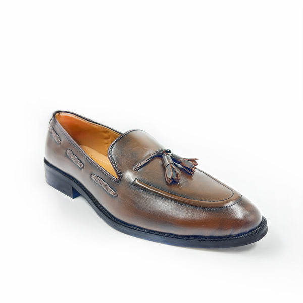 Brown leather loafer with tassel on a white background